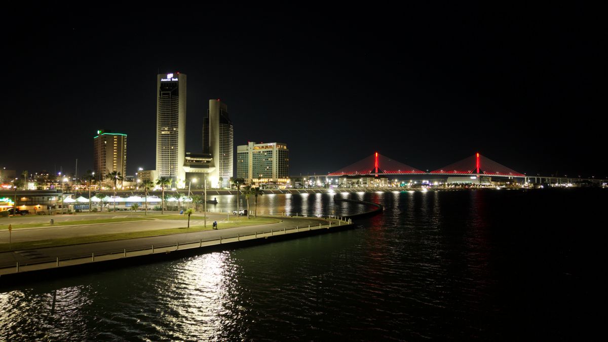 Corpus Christi skyline and the Harbor Bridge lit up at night over the bay